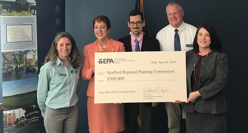 SRPC staff accept a large check from EPA staff for its Brownfields Program