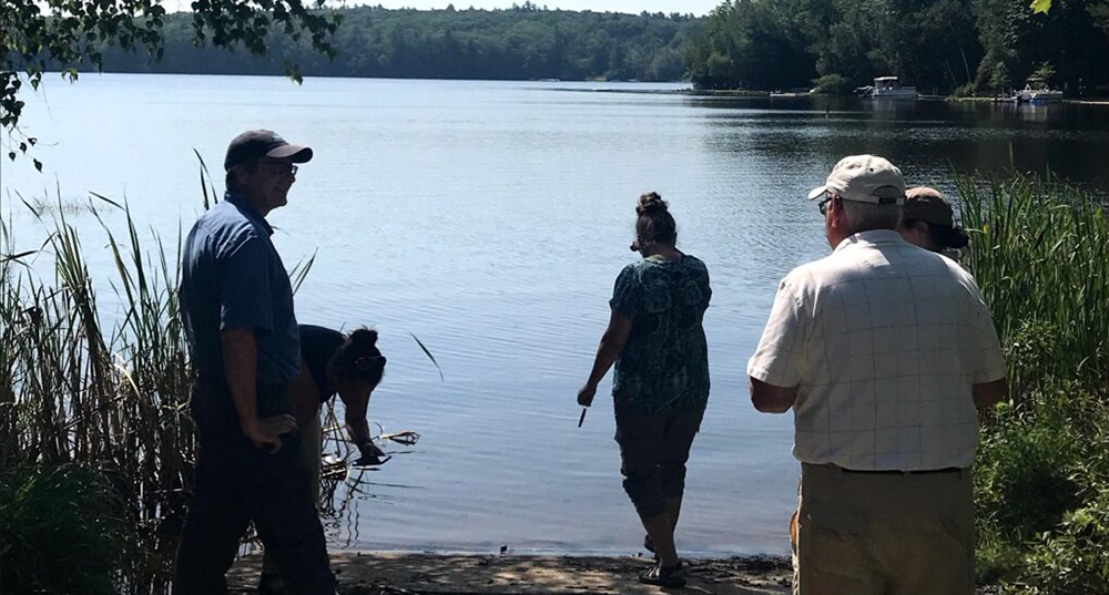 SRPC partners gather around a body of water to discuss watershed planning