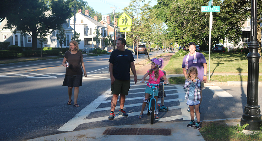 Parents walking with their children bike riding on Silver Street in Dover