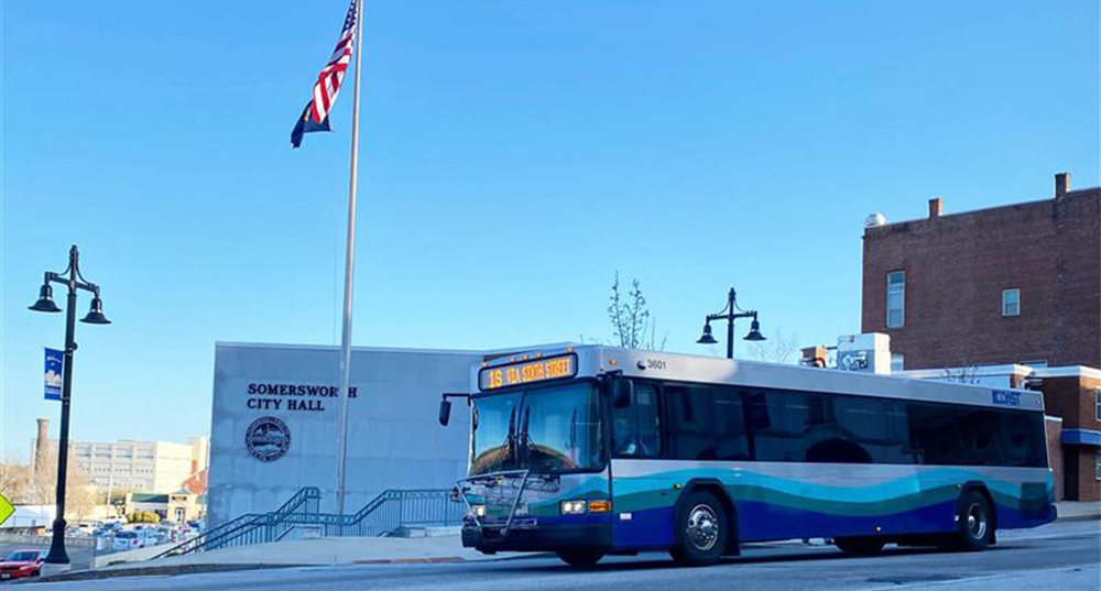 A Coast Bus drives by City Hall in Somersworth