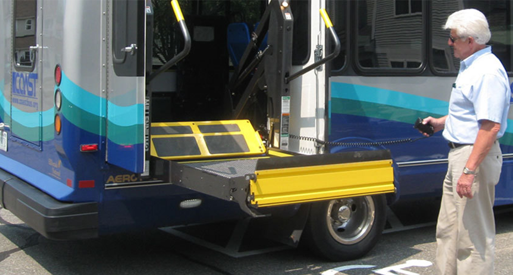 A COAST Bus lowers its ramp for ada accesibility