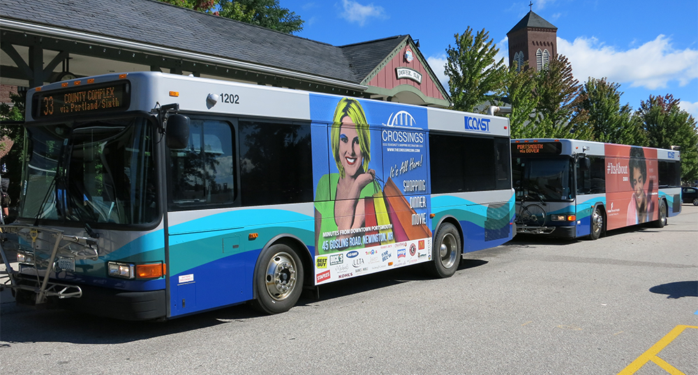 A COAST bus with ads for the Fox Run Mall lines up for passengers at the Dover Transportation Center
