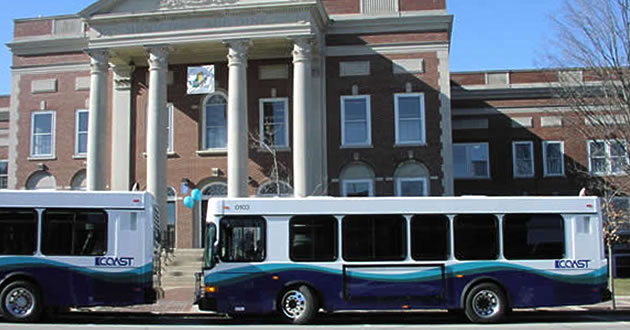 Two COAST buses wait in front of Dover City Hall