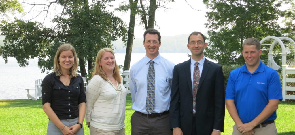 Panelist from the 2015 Tri-State Transit Conference pose in front of a lake
