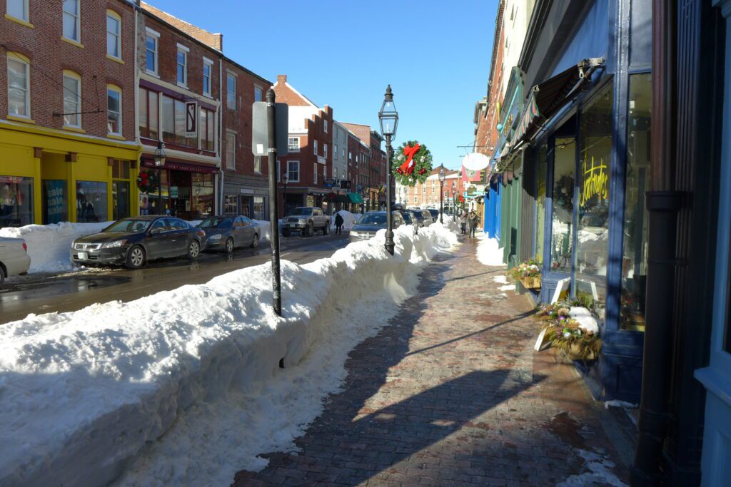 Snow plowed sidewalks in downtown Portsmouth amidst shops