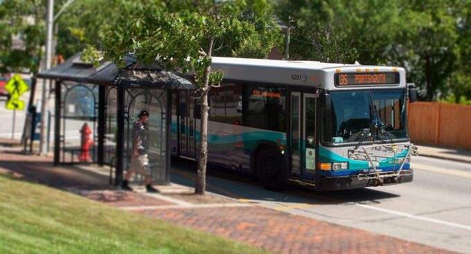 A COAST Bus stopping at a bus stop